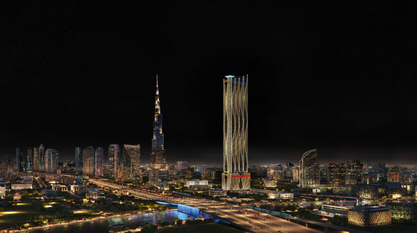 Vue nocturne de Dubaï avec ses gratte-ciels illuminés, dont l'emblématique Burj Khalifa. Le paysage urbain présente un mélange d'architecture moderne avec des bâtiments imposants, des lumières scintillantes et une atmosphère animée et animée sous un ciel étoilé.