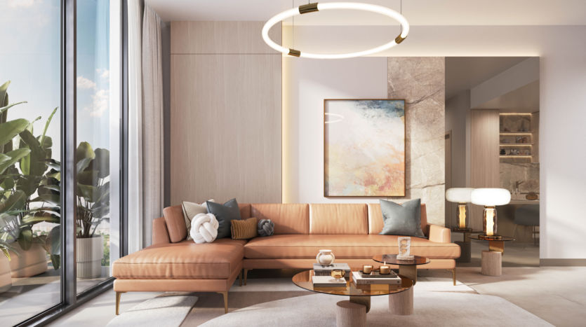 A modern living room with a beige leather sectional sofa and abstract artworks on the wall is illuminated by a round ceiling light. The Legado Prescott glass coffee table displays decorative objects, while large windows highlight the green plants outside, bathing the space in natural light.