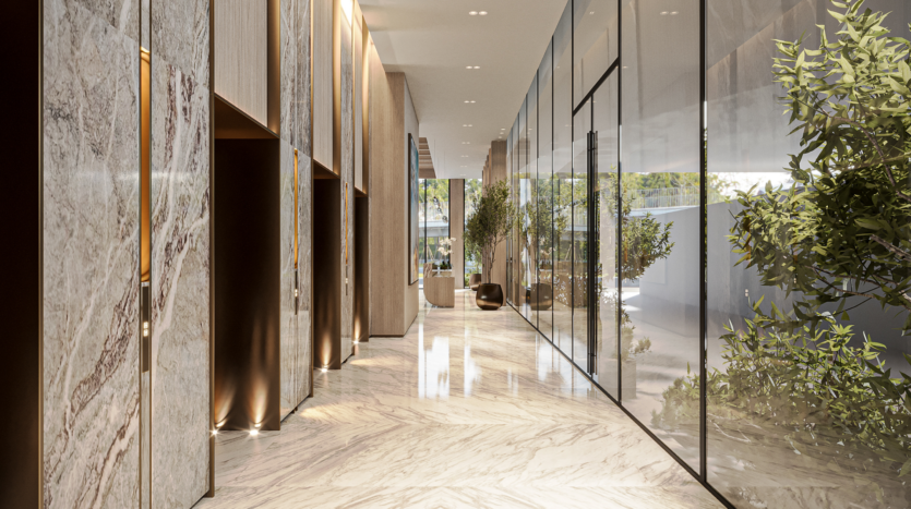 Luxurious, modern hallway with marble floors and walls, glass partitions and lush greenery. Subdued ceiling lighting creates a warm ambience. The space features sleek design elements and indoor plants.