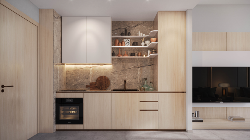 Modern kitchen with light wood cabinets, built-in oven and open shelving. Stone backsplash with accent lighting highlighting decorative objects. The Legado Prescott design reflects a minimalist style with neutral tones and clean finishes. Adjacent living space partially visible.