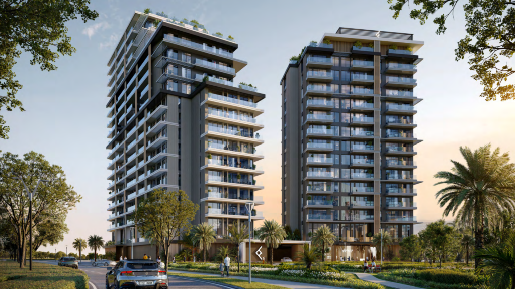 Two modern high-rise buildings, part of the Hillgate complex, are surrounded by greenery and palm trees under a clear sky. A road with a car and passers-by in the foreground leads invitingly to the entrance of this urban oasis.