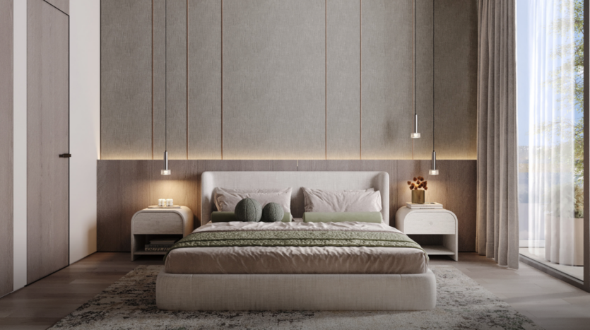 Une chambre moderne de l'Edition 3 présente une palette de couleurs neutres, avec un grand lit avec une literie verte et beige. Deux luminaires suspendus sont suspendus au-dessus des tables de chevet assorties, tandis qu'une fenêtre du sol au plafond du côté de la crique offre une vue sereine sur les arbres à l'extérieur.