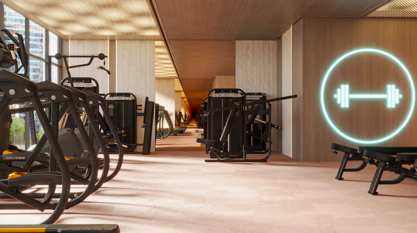 A modern gym interior with various exercise machines and benches lined up along the walls. A bright dumbbell icon adorns a wooden panel, and large windows offer a view of the city's buildings. The space is well lit and spacious.