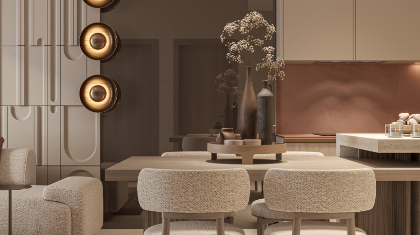 A modern dining room with a wooden table and upholstered chairs. Circular wall sconces are mounted on a textured wall and decorative vases with dried flowers adorn the table. The kitchen in the background features elegant cabinetry and warm lighting.