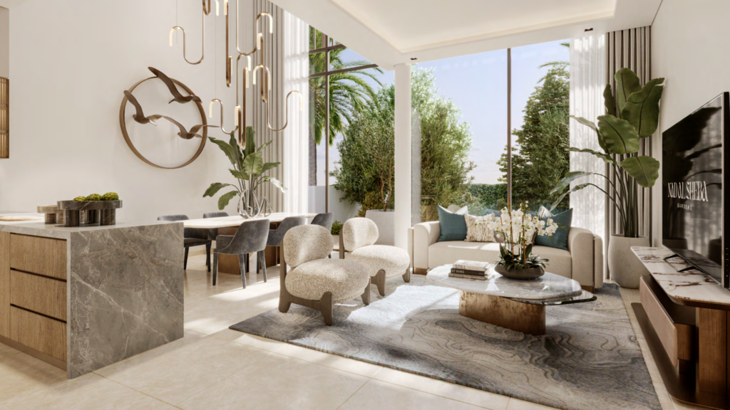 Un salon moderne à Nad Al Sheba dispose de grandes fenêtres, d'un îlot de cuisine en marbre, de chaises contemporaines, d'une table à manger en bois et d'un lustre élégant. L'espace lumineux est orné de plantes et offre une vue sereine sur le jardin extérieur.