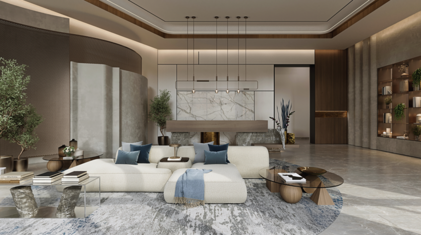 A modern living room with a white corner sofa adorned with blue and grey cushions. A geometric wooden coffee table and round side tables complete the decor. The room features a marble accent wall, pendant lighting, plants and a textured rug.