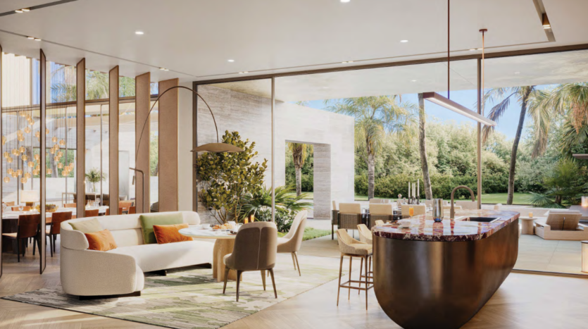 Luxueux espace de vie ouvert signé Bo Monde, doté de meubles modernes, d'un canapé blanc et d'une table ronde avec chaises. Un îlot de cuisine élégant avec tabourets de bar se trouve à proximité. Les baies vitrées offrent une vue imprenable sur le jardin luxuriant parsemé de palmiers.