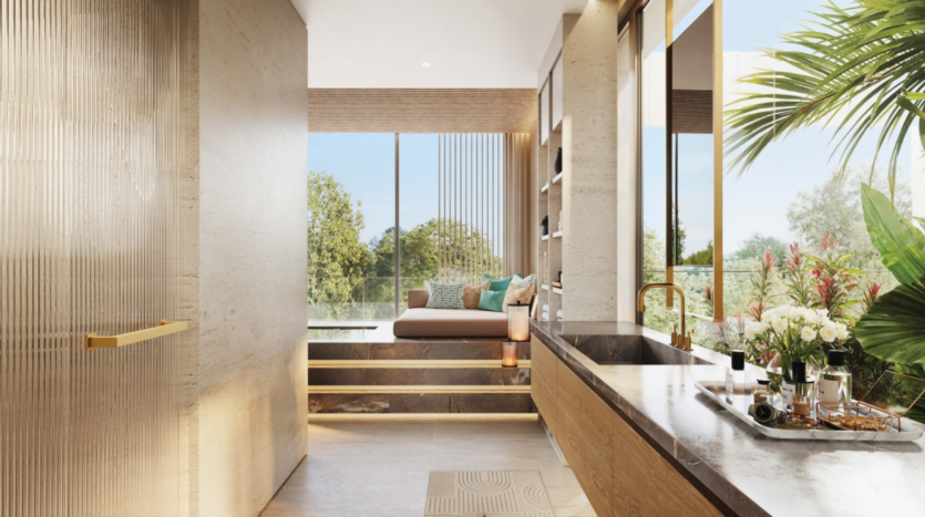 Cette salle de bains Bo Monde respire le luxe et la modernité, avec une grande fenêtre offrant une vue sur les arbres. Un banc rembourré et des marches complètent le lavabo élégant orné de luminaires dorés, tandis qu'un plateau de fleurs ajoute du charme. La lumière naturelle met en valeur le décor exquis en bois et en pierre.