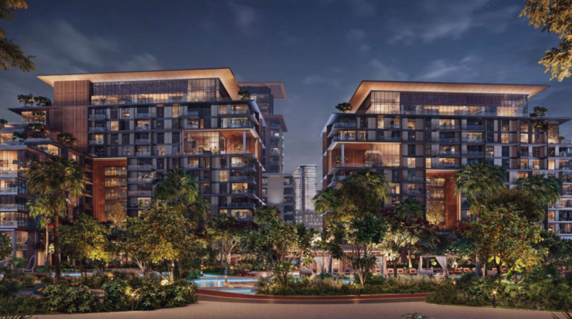 Vista notturna del complesso di appartamenti Crestlane, con due edifici moderni dotati di balconi. In primo piano, giardini paesaggistici con alberi e piscina, perfetti per una passeggiata in città. Sullo sfondo si intravede uno skyline urbano con un imponente edificio che rafforza l'atmosfera lussuosa.