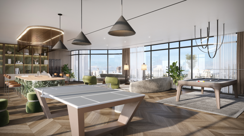 Verano is embodied in this modern living space featuring a ping-pong table and pool table. The room features large windows, a dining area with green velvet chairs, sophisticated lighting and lush plants. The contemporary decor harmoniously blends the textures of wood and marble.