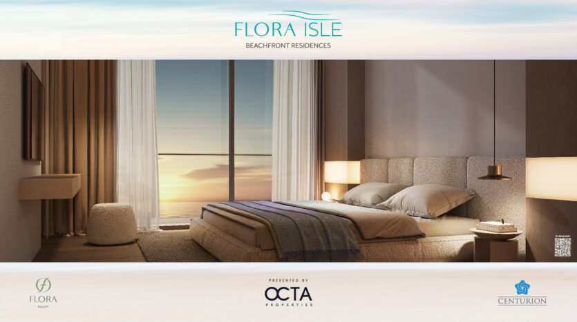 A comfortable seaside room on Flora Isle with a large window overlooking a serene sunset over the ocean. The room features a carefully made bed, a modern lamp and soft lighting. "Flora Isle Beachfront Residences" is displayed above, complemented by logos below.