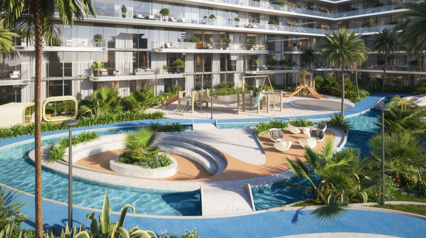 The courtyard of the Verano apartment complex features a winding pool with walkways, surrounded by tropical plants. Comfortable seating areas, a playground and multi-level balconies with glass balustrades overlook the lush landscape, creating a welcoming oasis.