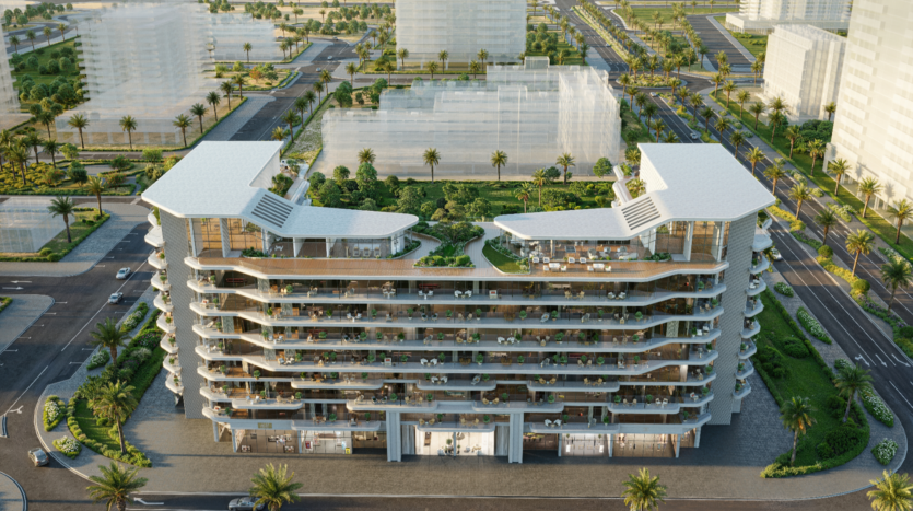 Aerial view of Verano, a modern multi-storey residential building with terraces, set amid landscaped gardens and palm trees. The surrounding streets and buildings blend harmoniously into the lively urban landscape.