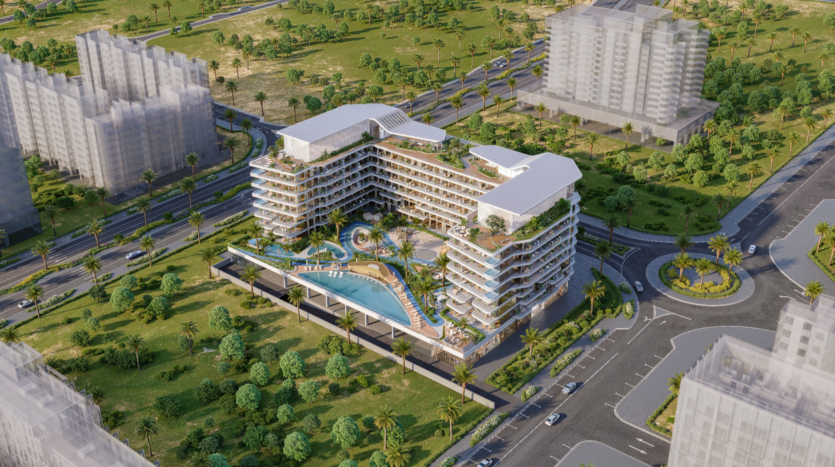 Aerial view of Verano, a modern multi-storey hotel with a unique angular design and rooftop pool. Surrounded by lush greenery, palm trees and city streets, with adjacent buildings and a traffic circle in the foreground.