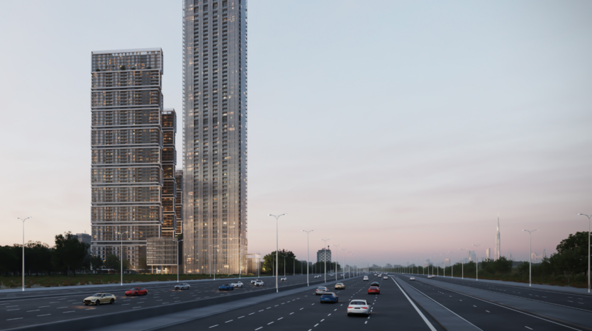 Un paesaggio urbano al tramonto è caratterizzato da un'autostrada trafficata con auto che viaggiano in entrambe le direzioni. A sinistra, due alti grattacieli, tra cui il magnifico Sobha One, si stagliano in un cielo colorato. La scena è splendidamente incorniciata dal verde su entrambi i lati, che aggiunge un elemento di tranquillità.