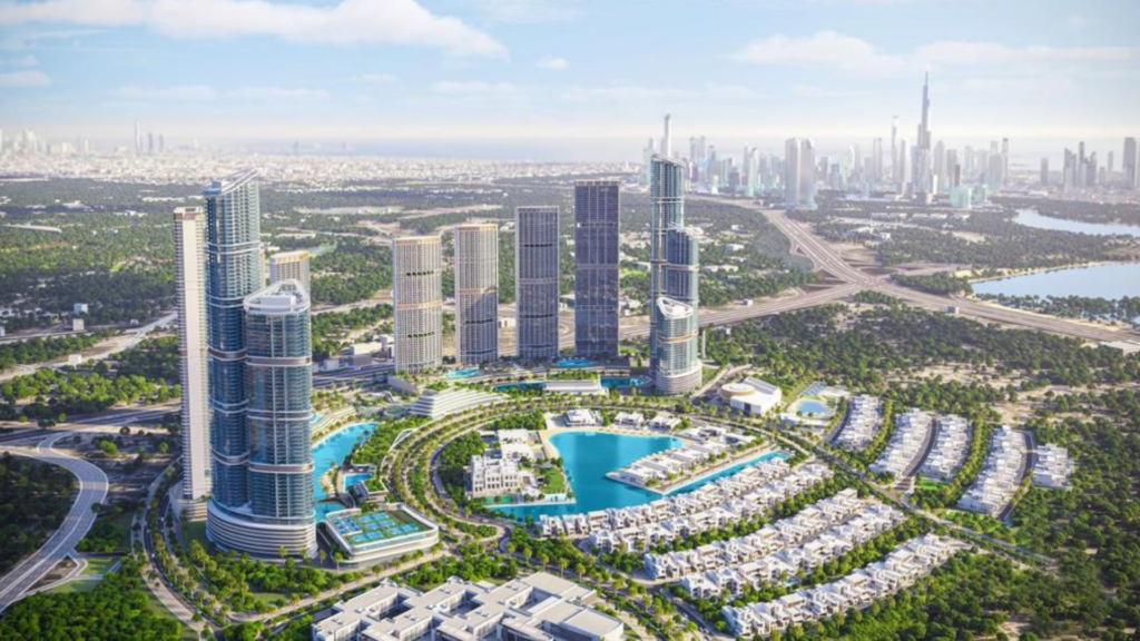 Aerial view of the futuristic SkyVue Spectra urban project, featuring tall skyscrapers, circular water features and lush green spaces. The distant city skyline with a prominent Sobha tower rises beneath the vast blue sky.