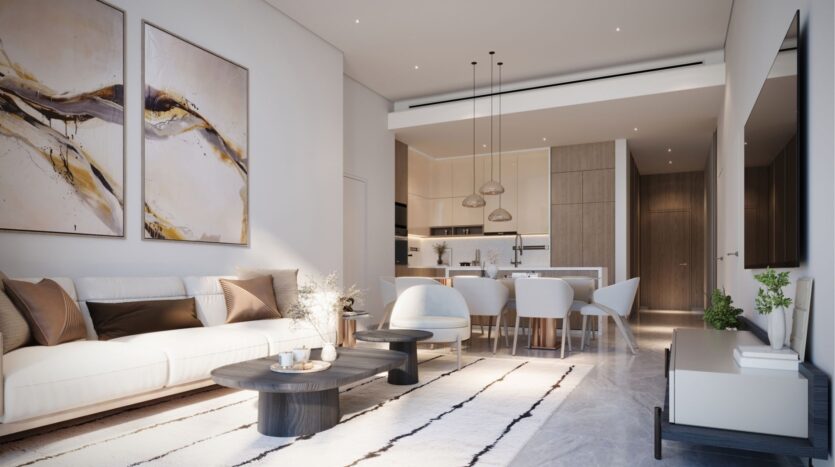 A modern living and dining room at DIFC Heights features a beige sofa, abstract paintings and white carpet. The dining area includes a wooden table, white chairs and hanging lights. The kitchen features wooden cabinets and a central island. This bright room is both spacious and contemporary.