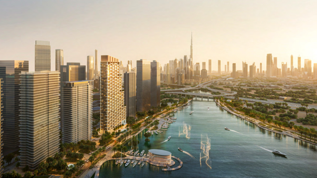 Aerial view of a modern city at sunset, with tall skyscrapers lining a peaceful waterfront in the Atelis design district. Boats are moored along the jetty, with an imposing tower visible in the distance. Lush vegetation surrounds the buildings.