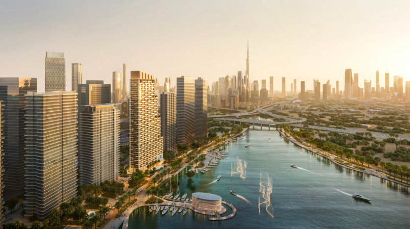 Aerial view of a modern city at sunset, with tall skyscrapers lining a peaceful waterfront in the Atelis design district. Boats are moored along the jetty, with an imposing tower visible in the distance. Lush vegetation surrounds the buildings.