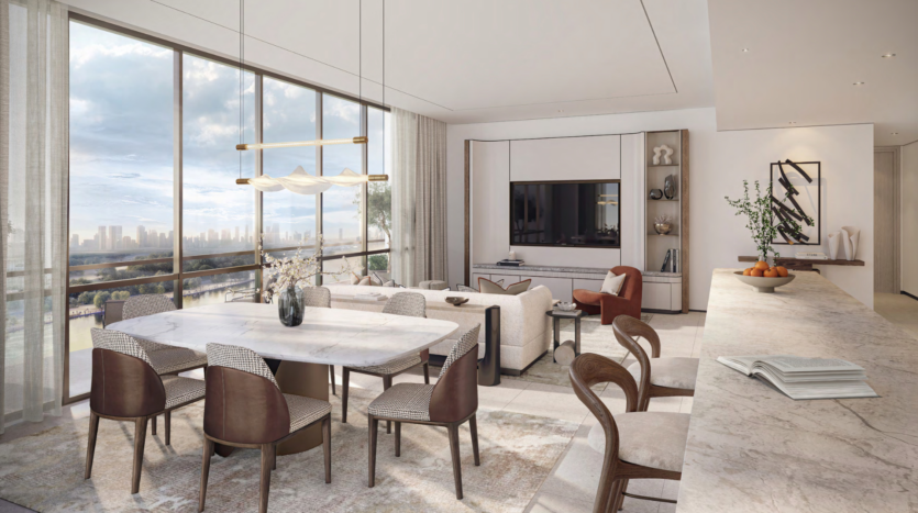 Discover a modern, open-plan living space in the heart of the Atelis design district. Featuring large windows with city views, this space includes a marble dining table, contemporary chairs, beige sofas and a kitchen island adorned with a book and fruit bowl. Neutral tones add a touch of serenity.