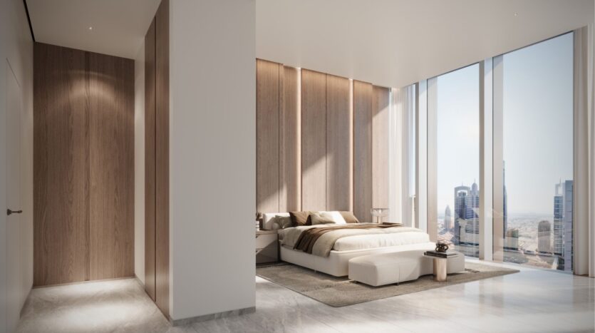 This modern room with its minimalist design features a king-size bed, wood-panelled walls and picture windows offering a breathtaking view of DIFC Heights. Subdued lighting highlights the neutral color palette, while a small, ornate table sits elegantly beside the bed.