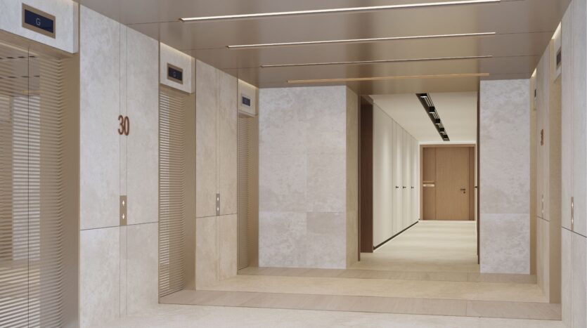 A modern elevator lobby at DIFC Heights features beige walls and ceiling, with three elevators equipped with digital screens. The wall displays the number 30, while a corridor with light-colored floors and wooden doors can be seen in the background.