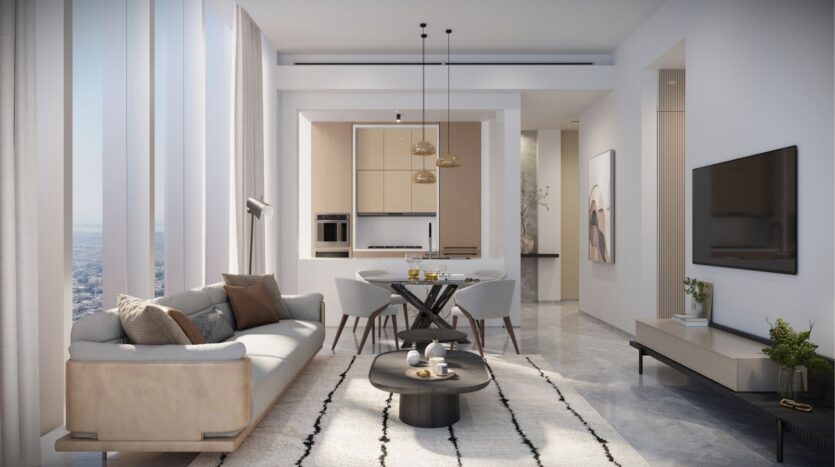 This modern living room in DIFC Heights features a beige sofa, round coffee table and wall-mounted TV. The dining room is equipped with an elegant table and chairs, under hanging lights. Large windows offer breathtaking views of the city, while neutral tones give the decor an elegant, minimalist style.