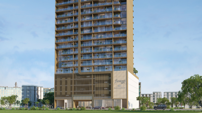 A large, modern building with glass balconies and a golden-brown facade, marked "Avagat" near the entrance. Cars and trees are visible in front, while other buildings rise nearby under Floarea's clear sky.