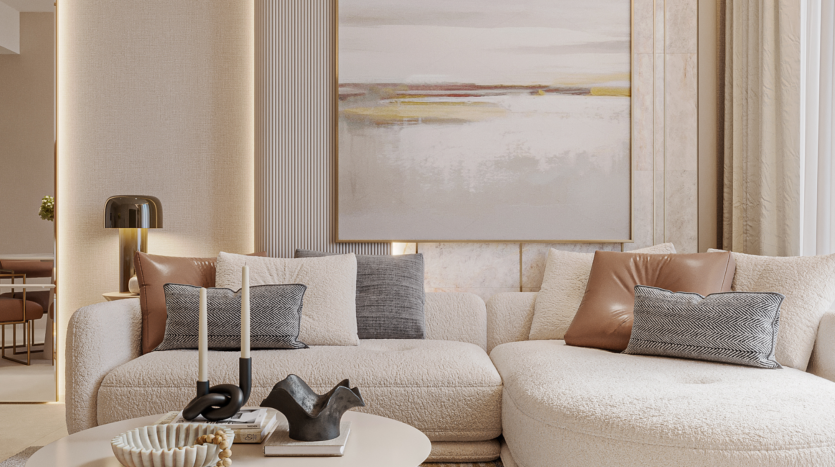 A modern living room with a curved white sofa, gray and brown cushions and a round coffee table adorned with candles and ornaments. A large abstract painting of a flowery sky adorns the wall, filling the space with warm neutral tones.