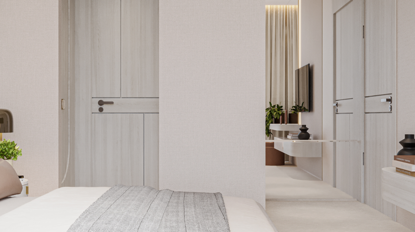 Minimalist room with light-colored walls and furniture, a bed with a gray blanket, floral sky artwork above the headboard, a closed wooden door, a wall-mounted TV, houseplants and decorative objects on a shelf and table.