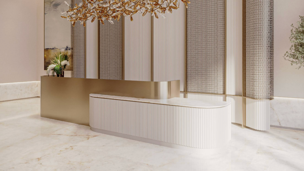 A luxurious lobby with an elegant, curved reception counter in white and gold. A large, artistic ceiling light reminiscent of the starry sky and textured walls add a touch of elegance. A potted plant sits atop the counter, while a light marble floor enhances the sophisticated atmosphere.