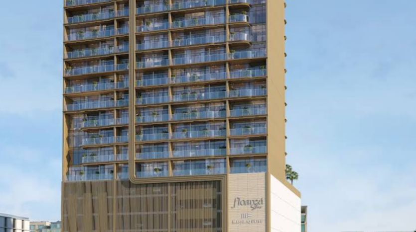 A large, modern apartment building, with a glass façade and multiple balconies, stands against a starry sky. The building features gold accents and a sign at the foot, whose name is illegible. Palm trees can be seen at the foot of the building.