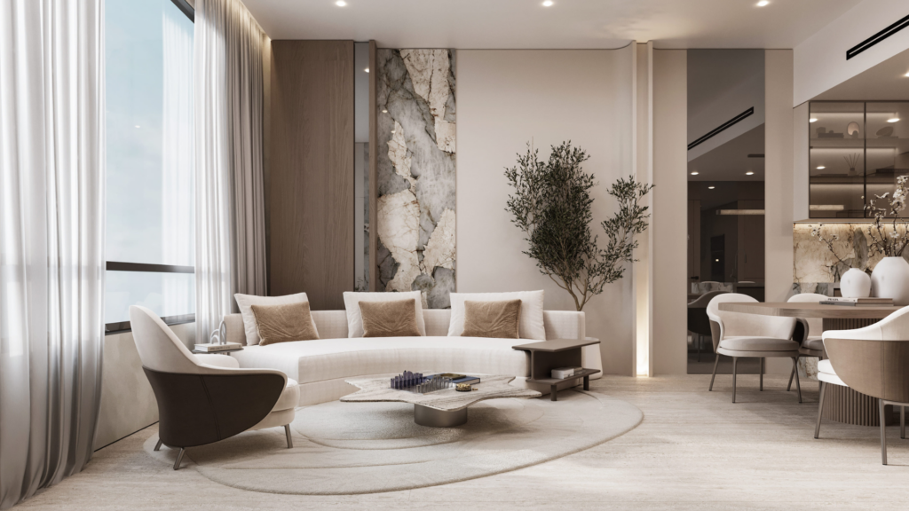 Modern living room with a curved white sofa, beige and beige cushions, a unique geometric coffee table, an accent wall with stone details, a potted tree, large windows with sheer curtains and neutral decor.