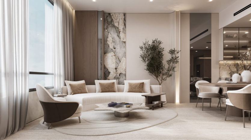 Modern living room with a curved white sofa, beige and beige cushions, a unique geometric coffee table, an accent wall with stone details, a potted tree, large windows with sheer curtains and neutral decor.