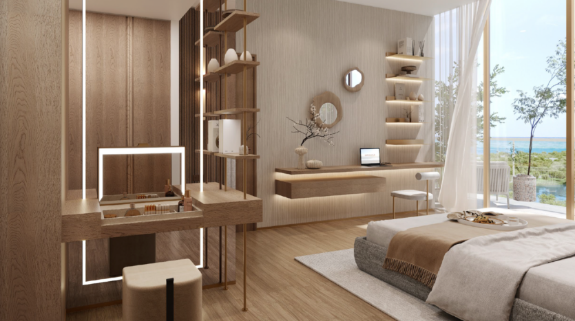 Una camera moderna e minimalista con mobili in legno chiaro, scaffali aperti, un comodo letto con biancheria neutra, una scrivania galleggiante con un computer portatile e ampie finestre con vista sugli alberi e sull'acqua di Wynnwood Dubai Island.