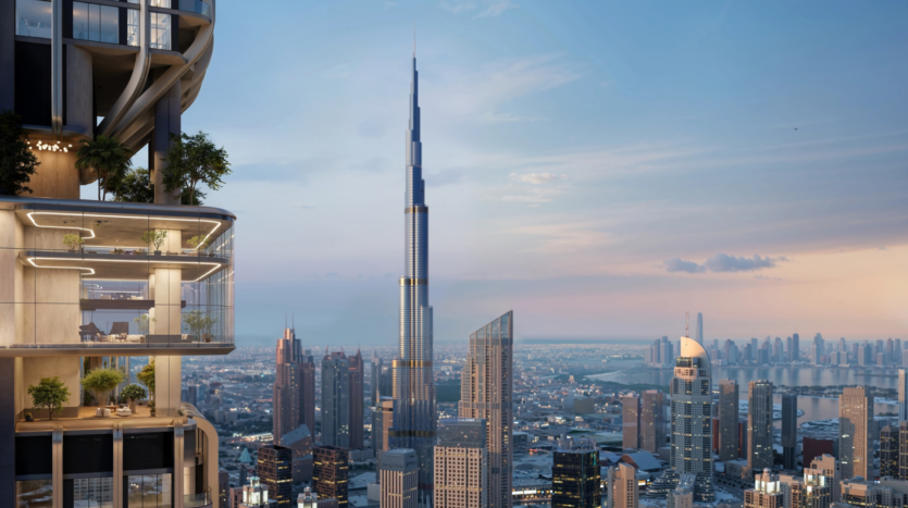 Modern cityscape at sunset, with the Burj Khalifa towering above Dubai's other skyscrapers. In the foreground, a raised balcony with plants and outdoor furniture overlooks the city.