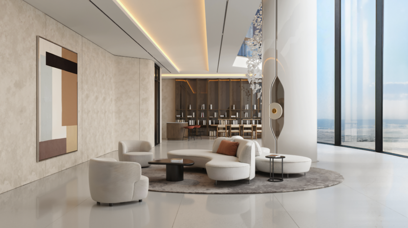A modern, elegant living room with cream-colored curved sofas, a round carpet, abstract wall art, bay windows offering ocean views and a large sculpture near an elegant bar in the background.