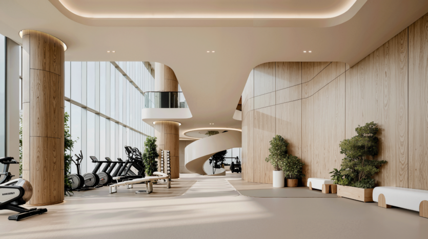 Modern gym with large windows, indoor plants, exercise bikes, treadmills, benches and free weights. Curved wooden walls and a spiral staircase create a bright, open and welcoming atmosphere.
