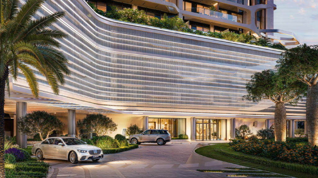 A modern luxury hotel entrance with elegant architectural design, illuminated curved lines, lush landscaping and two parked cars - a white sedan and a silver SUV - near the glass entrance.