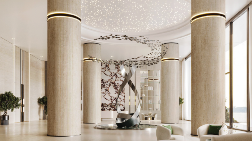 A modern lobby with tall cylindrical columns, a central abstract metal sculpture, star-like ceiling lights, large windows and elegant seating with plants and light furniture.