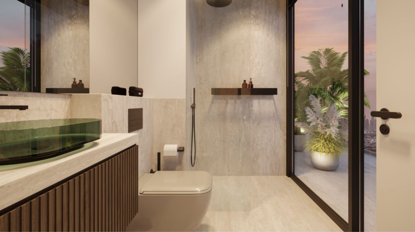 Modern bathroom with floating toilet, green glass sink, large mirror, minimal decor and glass door opening onto a terrace with potted plants at sunset. Neutral colors and sleek design elements are omnipresent.