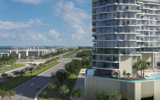 Ein modernes Hochhaus mit Glasbalkonen überblickt eine breite, palmengesäumte Straße auf der Insel Octa auf der Insel Dubai, wobei zeitgenössischere Gebäude und der Ozean im Hintergrund unter einem teilweise bewölkten Himmel zu sehen sind.