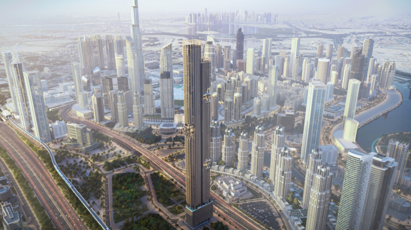 Aerial view of a modern city with numerous skyscrapers, freeways and green spaces; the tallest building stands out prominently in the middle of the dense urban landscape.