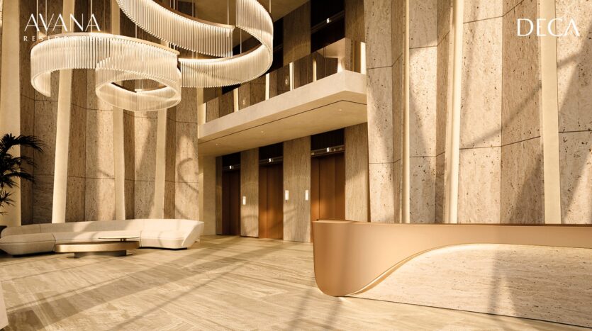 The modern, spacious lobby of Avana Residences by Deca Properties in Dubai features large stone walls, an elegant curved reception desk, a white sofa, three elevators and elegant circular chandeliers. The AVANA and DECA logos are displayed in the corners.