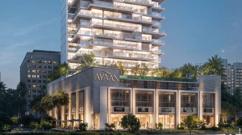 Ayaan Heights 1 by IGO is a modern multi-storey building christened "Ayaan", featuring stores on the lower floors and a tower above with balconies and greenery, beautifully illuminated at night.