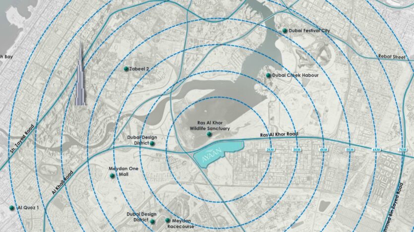 A digital map of Dubai shows blue concentric circles centered on Ras Al Khor Wildlife Sanctuary, highlighting Ayaan Heights 1 by IGO as well as nearby areas such as Dubai Design District, Meydan Racecourse, and Dubai Festival City.