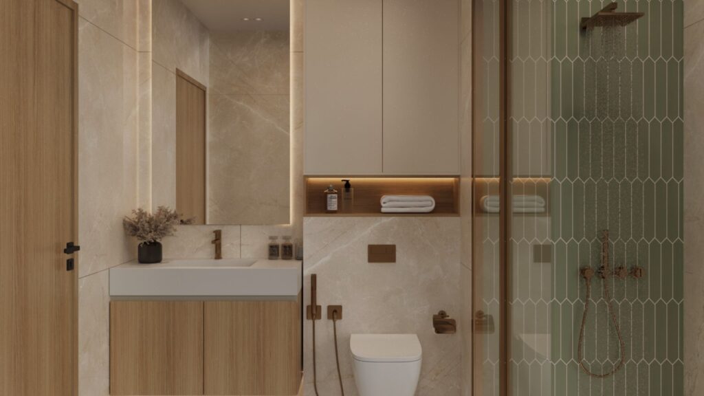 The modern bathroom in Ayaan Heights 1 by IGO features beige marble walls, a wooden vanity with sink, wall-mounted toilet, shelves with towels and decorative items, and a glass-enclosed shower with vertical tiles and bronze fittings.