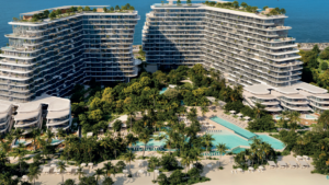 Luftaufnahme von zwei modernen, geschwungenen Hotelgebäuden am Meer in Passo by Beyond Palm Jumeirah, umgeben von üppiger Vegetation, mehreren Pools, Palmen, Entspannungsbereichen und einem Sandstrand mit Blick auf den Ozean im Hintergrund.