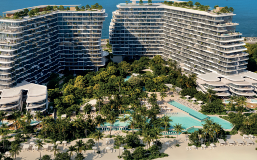 Luftaufnahme von zwei modernen, geschwungenen Hotelgebäuden am Meer in Passo by Beyond Palm Jumeirah, umgeben von üppiger Vegetation, mehreren Pools, Palmen, Entspannungsbereichen und einem Sandstrand mit Blick auf den Ozean im Hintergrund.