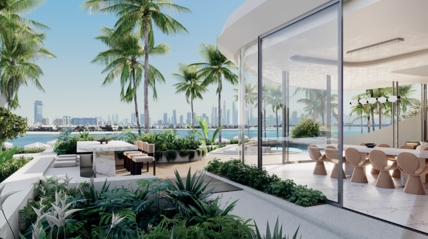 A modern, glass-enclosed dining room opens onto a lush terrace with seating, tropical plants, palm trees and a view of the city skyline under a clear blue sky.